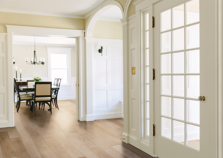 warm toned hardwood flooring in hallway.